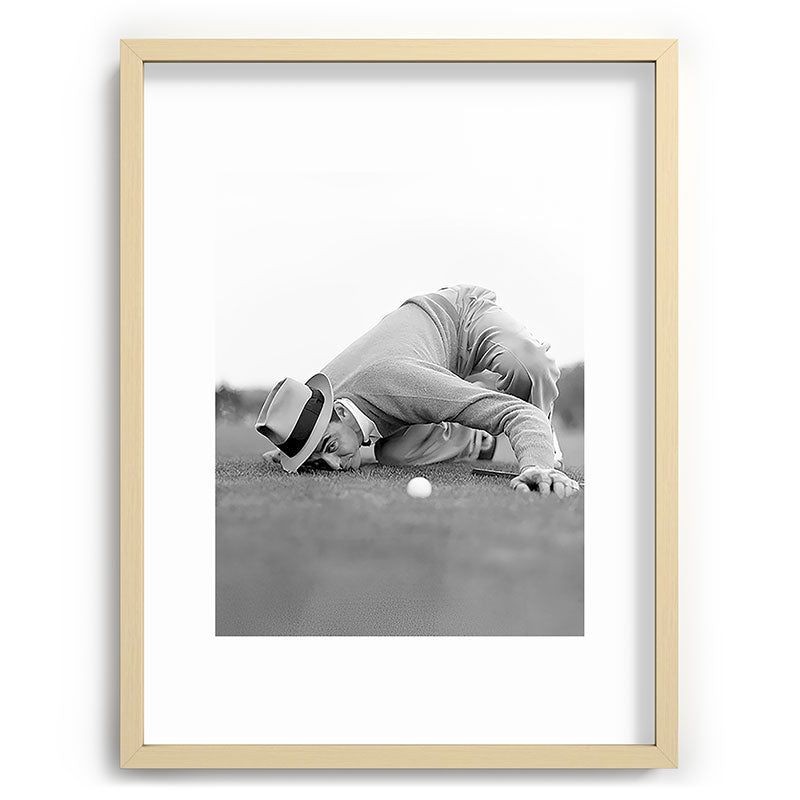 Eye to the ground on the 18th hole; golfing man eyes ball to measure distance to hole vintage black and white portrait photograph - photography - photographs poster Framed Art Print Gallery Image 99