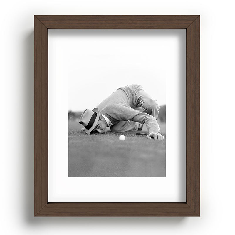 Eye to the ground on the 18th hole; golfing man eyes ball to measure distance to hole vintage black and white portrait photograph - photography - photographs poster Framed Art Print Gallery Image 86
