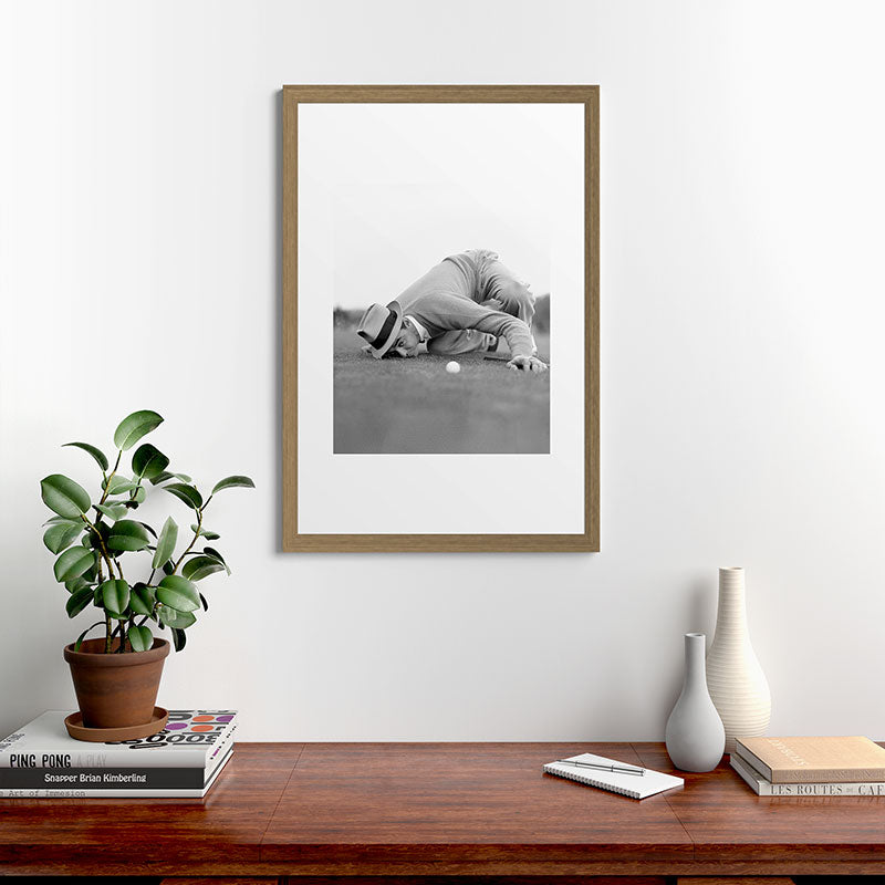 Eye to the ground on the 18th hole; golfing man eyes ball to measure distance to hole vintage black and white portrait photograph - photography - photographs poster Framed Art Print Gallery Image 56