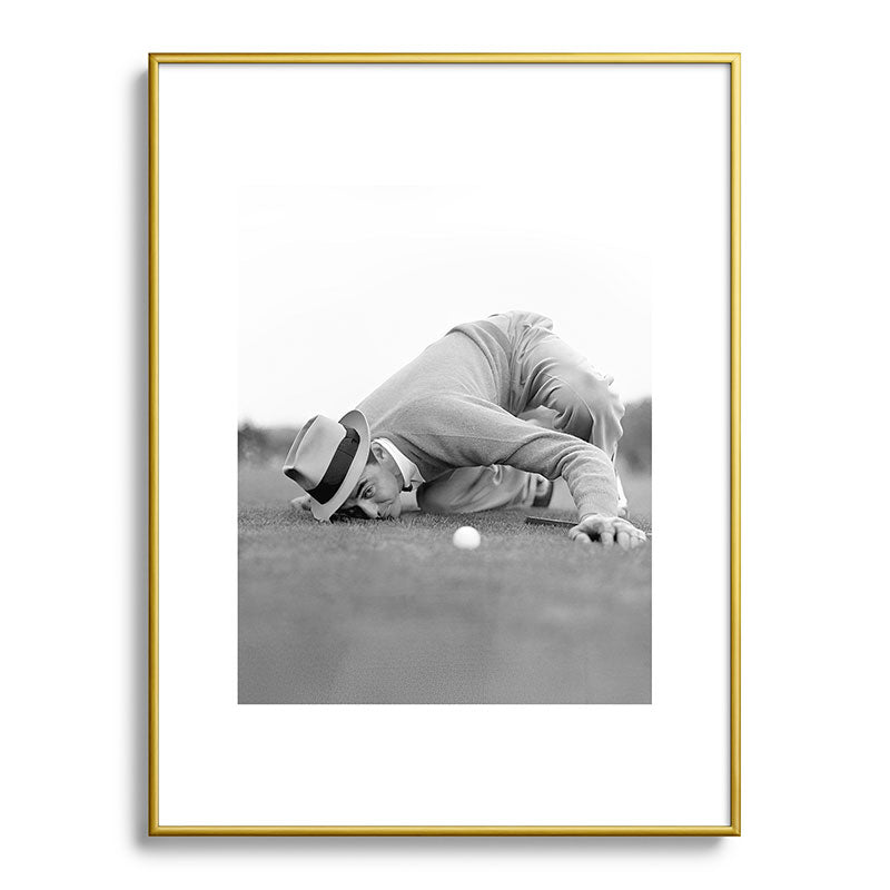 Eye to the ground on the 18th hole; golfing man eyes ball to measure distance to hole vintage black and white portrait photograph - photography - photographs poster Framed Art Print Gallery Image 125