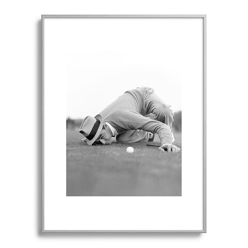 Eye to the ground on the 18th hole; golfing man eyes ball to measure distance to hole vintage black and white portrait photograph - photography - photographs poster Framed Art Print Gallery Image 135