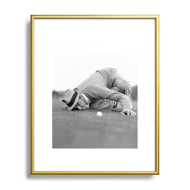 Eye to the ground on the 18th hole; golfing man eyes ball to measure distance to hole vintage black and white portrait photograph - photography - photographs poster Framed Art Print Gallery Image 120