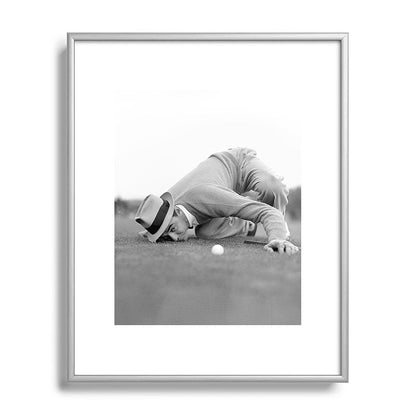 Eye to the ground on the 18th hole; golfing man eyes ball to measure distance to hole vintage black and white portrait photograph - photography - photographs poster Framed Art Print Gallery Image 131