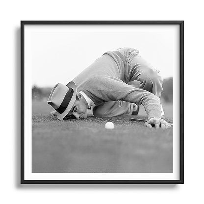Eye to the ground on the 18th hole; golfing man eyes ball to measure distance to hole vintage black and white portrait photograph - photography - photographs poster Framed Art Print Gallery Image 122