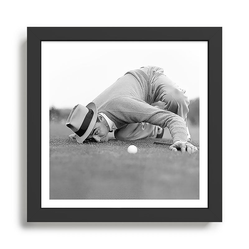 Eye to the ground on the 18th hole; golfing man eyes ball to measure distance to hole vintage black and white portrait photograph - photography - photographs poster Framed Art Print Gallery Image 2